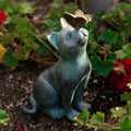 Curious cat with butterfly statue